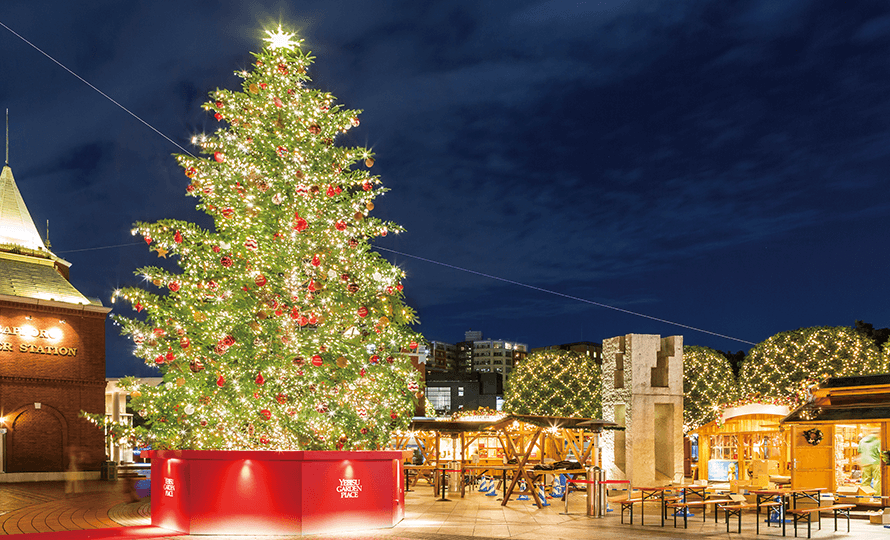 Christmas Marche surrounds the tree.